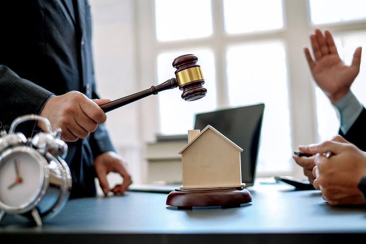 Toronto real estate lawyer's desk with a gavel and house model, representing legal authority and expertise in real estate law